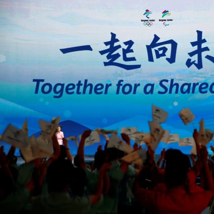 The slogan for the Beijing 2022 Winter Olympics, “Together for a shared future”, is unveiled on a giant screen at a ceremony in Beijing. Photo: Reuters