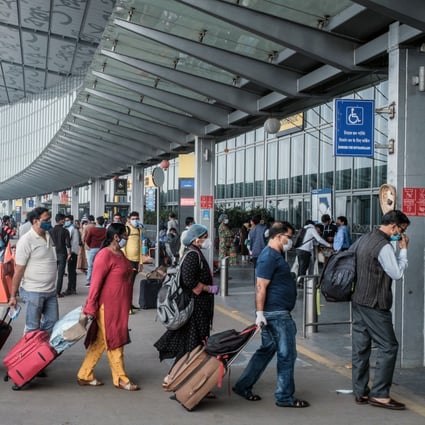 Travellers wearing face masks arrive at an airport in Kolkata, India, amid the pandemic. Photo: Bloomberg