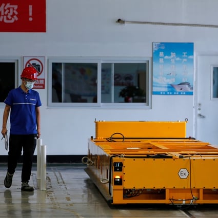 An employee inspects an automated guided vehicle at a Lonyu Robot Co factory in Tianjin on September 7. Photo: Reuters