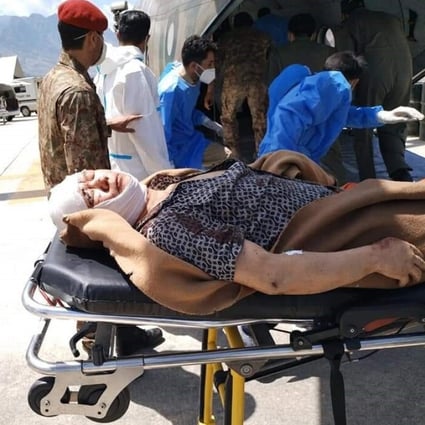 Pakistani rescuers attend to people injured in a suspected suicide bomb attack on a bus carrying Chinese engineers to the Dasu Dam in Kohistan. Photo: EPA