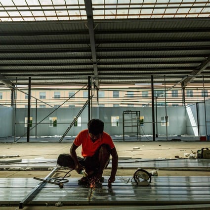 A labourer works on a new Covid-19 quarantine centre in Muse, near the China-Myanmar border. Photo: AFP