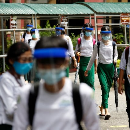 Students wearing masks and face shields leave after attending the first day of school in Yangon, Myanmar. Photo: AFP