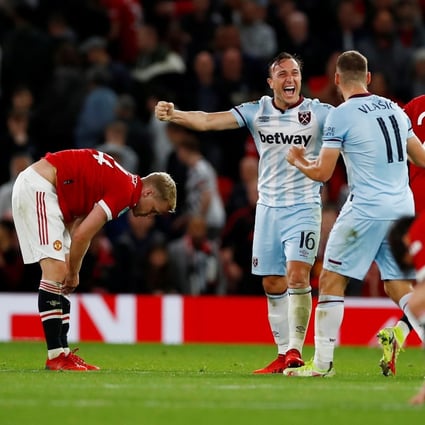 West Ham United’s Mark Noble celebrates with Nikola Vlasic as Manchester United’s Donny van de Beek looks dejected after the match. Photo: Reuters