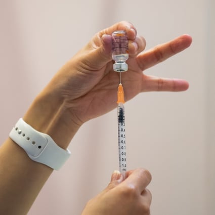 A nurse fills a syringe with a dose of the Sinovac vaccine at a community vaccination centre in Hong Kong. Photo: Getty Images via TNS