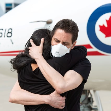 Former diplomat Michael Kovrig embraces his wife Vina Nadjibulla in Toronto following his arrival on a Canadian air force jet. Photo: Reuters