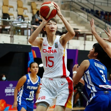 China centre Han Xu is guarded by Afril Bernardino and Karl Ann Pingol of the Philippines during the 2021 FIBA Women's Asia Cup group B basketball match. Photo: AFP