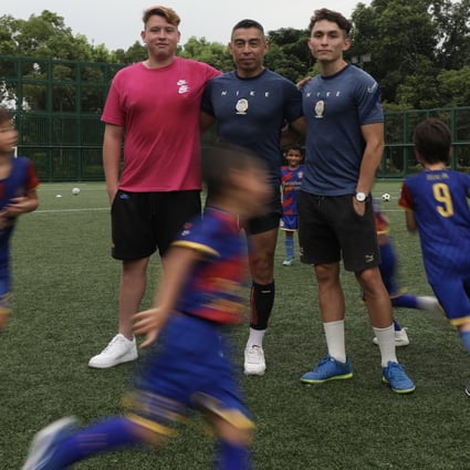 Hong Kong football coach Oscar Benavides (centre) and his two sons Oscar Jnr and Nicholas, in a training session in Man Tung Park Road pitches in Tung Chung. Photo: SCMP / Xiaomei Chen