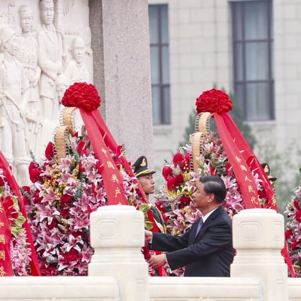 Xi Jinping inspects the wreaths laid at the Martyr’s Memorial in Tiananmen Square. Photo: Simon Song