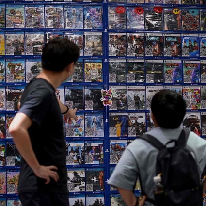 People look at console games at a store in Beijing on August 31, 2021, a day after China announced a drastic cut to children’s online gaming time to just three hours a week. Photo: AFP