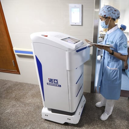 Chen Xiaofang, a nurse at Guangdong Second Provincial General Hospital, operates a robot to deliver supplies to patients in Guangzhou, the capital of Guangdong province, on September 26. Photo: SCMP/Simon Song