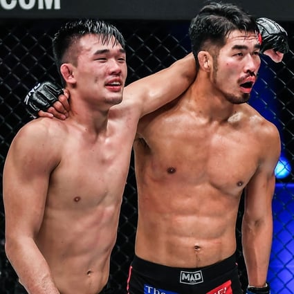 Christian Lee and Ok Rae-yoon embrace after their five-round lightweight title fight at ONE: Revolution. Photos: ONE Championship
