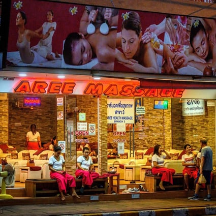 Employees wait for customers outside a massage parlour in Pattaya. Photo: AFP