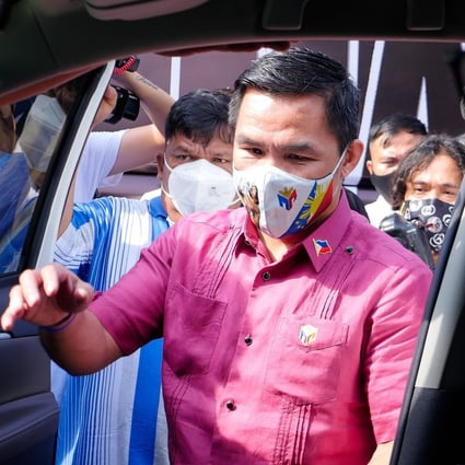 Senator and boxing icon Manny Pacquiao gets in a car on his way to file his candidacy to run for president. Photo: DPA