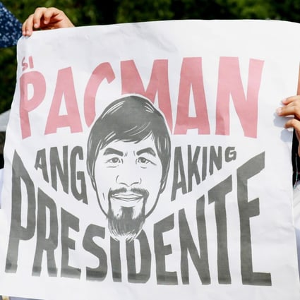 A supporter of Manny Pacquiao carries a banner as he files for candidacy for president on October 1, 2021. Photo: EPA-EFE