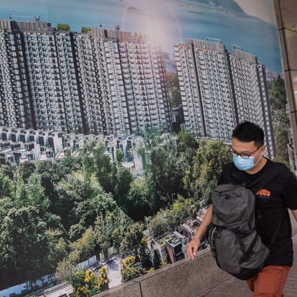 A man walks past a poster showing China Evergrande’s Emerald Bay property project in Hong Kong. Photo: EPA-EFE