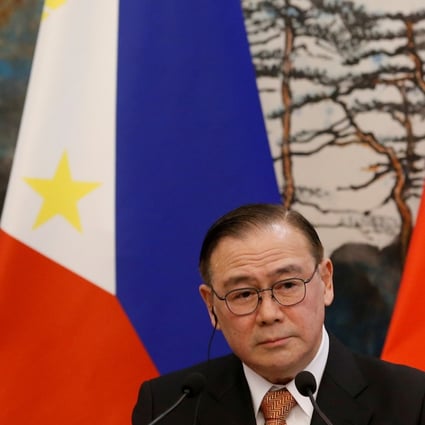 Philippine Foreign Secretary Teodoro Locsin Jnr is pictured in front of Philippine and Chinese flags after talks in Beijing. Manila is balancing its interests as it reconsiders its position on the Aukus alliance. Photo: Reuters