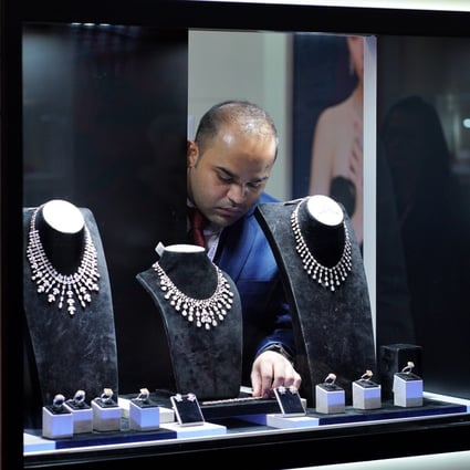 An exhibitor arranges jewellery at the Jewellery & Gem World show in Hong Kong, in September 2019. Photo: Xinhua