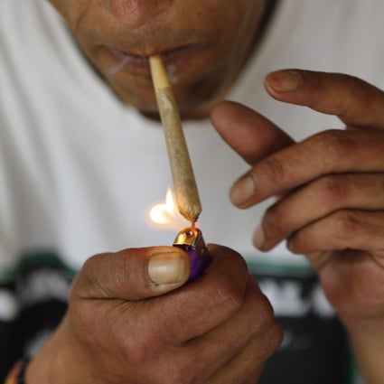 A visitor smokes marijuana at a retreat in the mountains surrounding Kathmandu. Campaigners are seeking to legalise cannabis in Nepal. Photo: AP