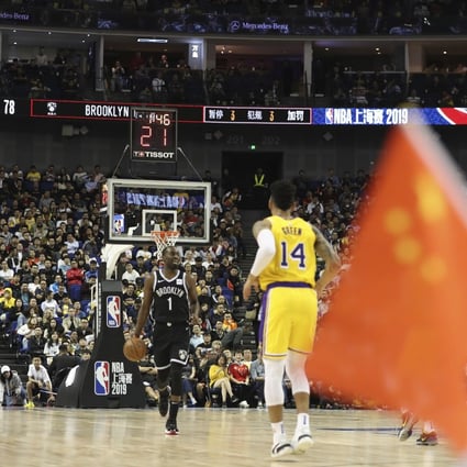 Brooklyn Nets’ Theo Pinson drives against the Los Angeles Lakers' Danny Green near a Chinese national flag during an NBA China Games. Photo: AP