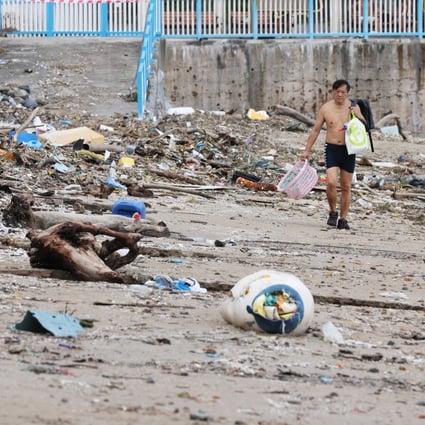 A man walks past piles of rubbish on Silverstrand Beach in Sai Kung on Thursday. Photo: May Tse