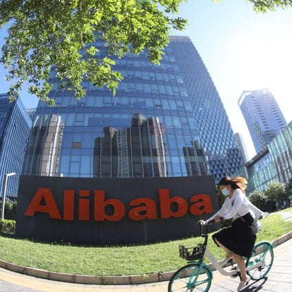 A woman rides past an Alibaba office building in Beijing, China, on August 26, 2021. Photo: Simon Song