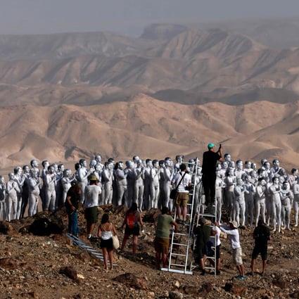 American art photographer Spencer Tunick and his crew work on a photo installation in the desert near the Israeli city of Arad on Sunday. Photo: Menahem Kahana / AFP
