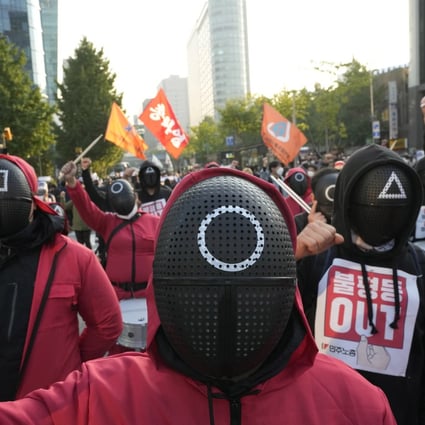 Members of the South Korean Confederation of Trade Unions wear masks and costumes inspired by the Netflix hit as they attend a rally in Seoul demanding job security. Photo: AP