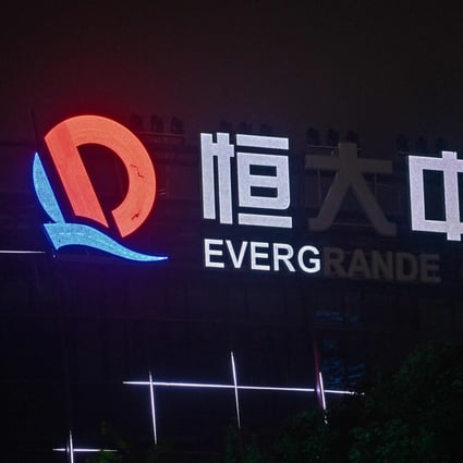 A partially illuminated sign of the Evergrande Center sign at the developer’s building in Shanghai on October 9, 2021. Photo: AFP