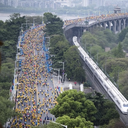Participants run along the Wuhan Yangtze River Bridge at the 2019 Wuhan Marathon. The event has not taken place since. Photo: Xinhua