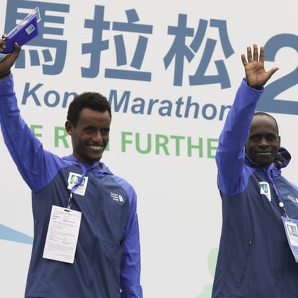 Winner Barnabus Kiptum of Kenya (right) and second-place Dawit Wolde of Ethiopia on the podium after breaking the Hong Kong Marathon men’s course record at Victoria Park in 2019. Photo: Edmond So