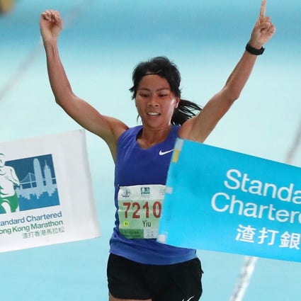 Christy Yiu Kit-ching celebrates at the finish line at Victoria Park in Causeway Bay after winning the half marathon at the 2019 Standard Chartered Hong Kong Marathon. Photo: Nora Tam
