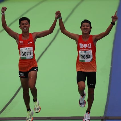 Chan Ka-ho an Gi Ka-man come home hand in hand to win the Hong Kong men's half marathon. Photo: Nora Tam