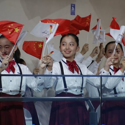 Children wave Chinese national flags at the welcome ceremony for the flame of the Beijing 2022 Winter Olympic Games. China now follows in Tokyo 2020’s footsteps for the second Games during the pandemic. Photo: EPA