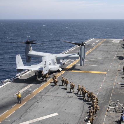 US Marines load into a V-22 Osprey, a tiltrotor helicopter. Photo: US Navy/AFP