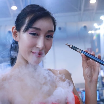 A model smokes an electronic cigarette during the Beijing International Vapour Distribution Alliance Expo at China International Exhibition Center on July 23, 2015 in Beijing, China. Photo: Getty