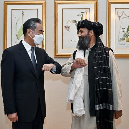 Chinese Foreign Minister Wang Yi with Mullah Abdul Ghani Baradar in Doha, Qatar, on Monday. Photo: EPA-EFE