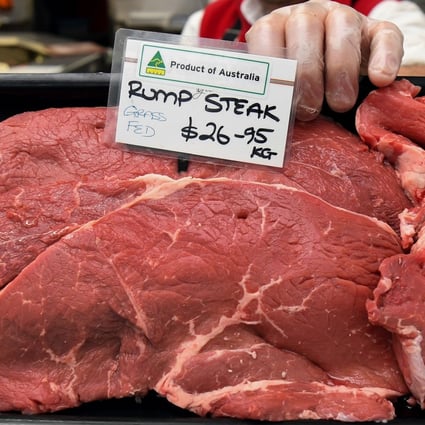 A butcher holds up a tray of Australian rump steaks in Melbourne. File photo: AFP