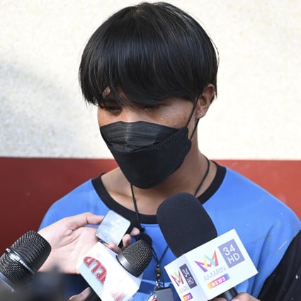 One of the painters, a Myanmar national identified as Song, talks to reporters at Pak Kret police station on Wednesday. Photo: AP