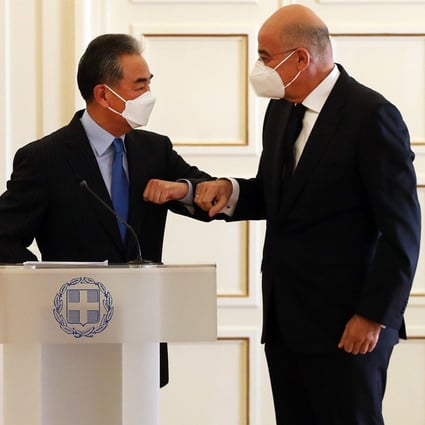 Foreign Minister Wang Yi is greeted in Athens by his Greek counterpart Nikos Dendias. Photo: EPA-EFE