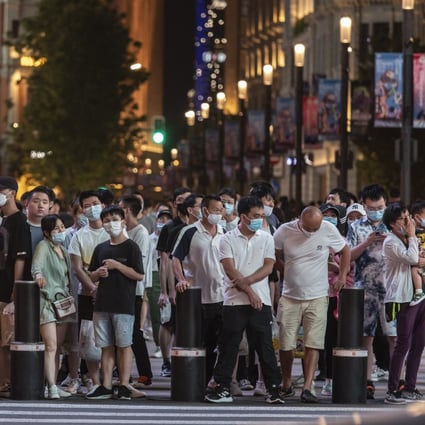 Shoppers and pedestrians wait at a traffic signal at Nanjing Road in Shanghai. For data gathered from the personal information of more than 1 million Chinese, a government review is mandatory before moving it across the border. Photo: Bloomberg