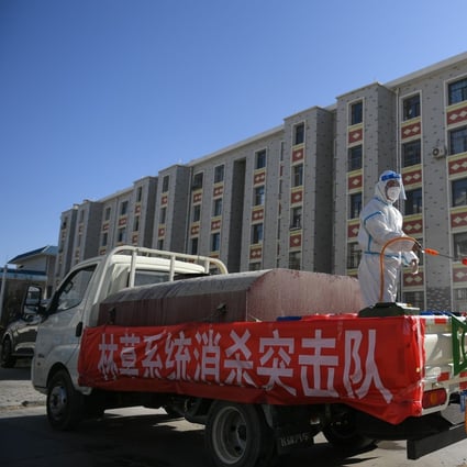 Workers disinfect a residential area in Ejina Banner, Inner Mongolia, on Wednesday as part of efforts to contain a coronavirus outbreak. Photo: Xinhua