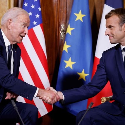 French President Emmanuel Macron (right) and US President Joe Biden shake hands during their meeting at the French embassy to the Vatican in Rome on Friday. Photo: AFP