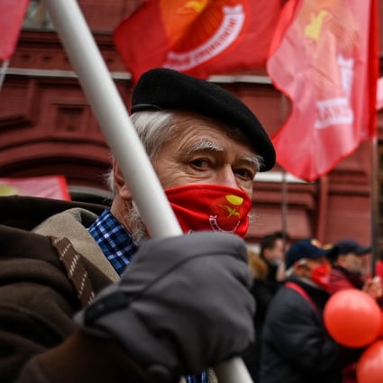 A Russian Communist Party supporter wearing a protective mask attends an annual wreath-laying ceremony in a deserted Red Square amid the Covid-19 pandemic in Moscow on Friday. Photo: AFP