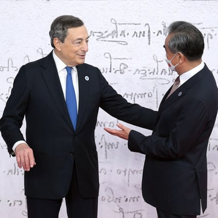 Italian Prime Minister Mario Draghi welcomes Chinese Foreign Minister Wang Yi as he arrives for the G20 summit in Rome on Saturday. Photo: EPA-EFE
