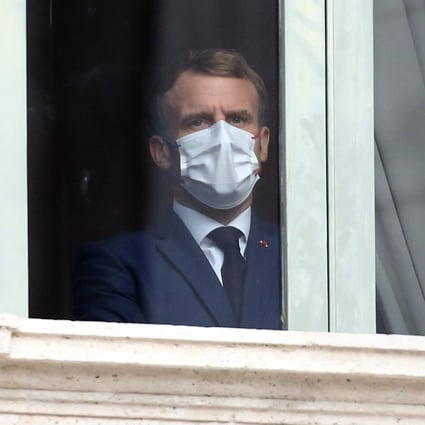 Emmanuel Macron, France's president, looks out from a window before a G20 leaders visit to the Trevi fountain in Rome, Italy. Photo: Bloomberg