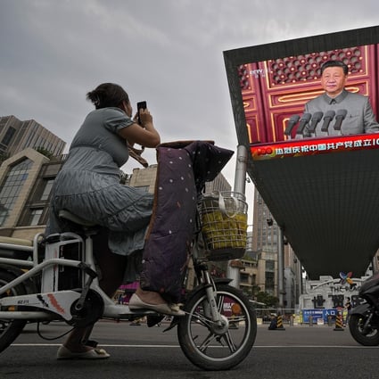 A video screen outside a shopping centre in Beijing showing Chinese President Xi Jinping speaking. Photo: AP Photo