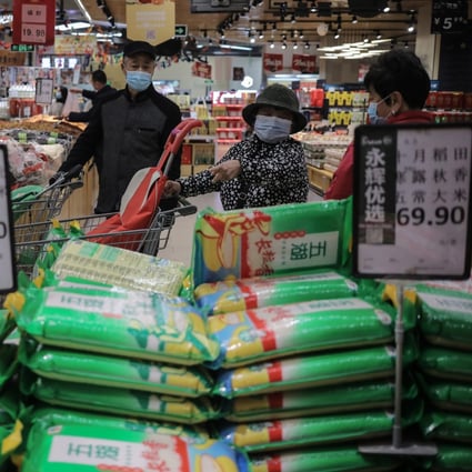 Supermarket shoppers are pictured in Beijing on November 2. China’s Ministry of Commerce told families to keep daily necessities in stock in case of emergency after Covid-19 outbreaks and unusually heavy rain. Photo: EPA-EFE