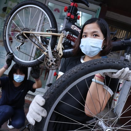Ke Hui-min (right) is one of 30 mums undergoing bike maintenance training at a social enterprise. Photo: May Tse