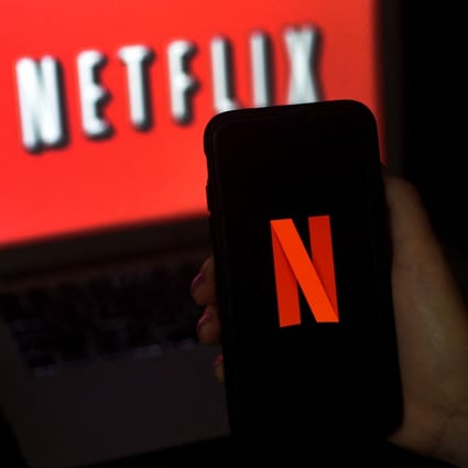 A computer screen and mobile phone display the Netflix logo on March 31, 2020. The streaming giant has launched its first video game service on Android with games based on its hit series Stranger Things. Photo: AFP