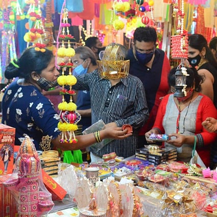 People in Mumbai shop for paper lanterns and other decorative items ahead of Diwali. Photo: AFP